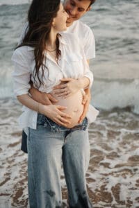 Couple maternity session beach