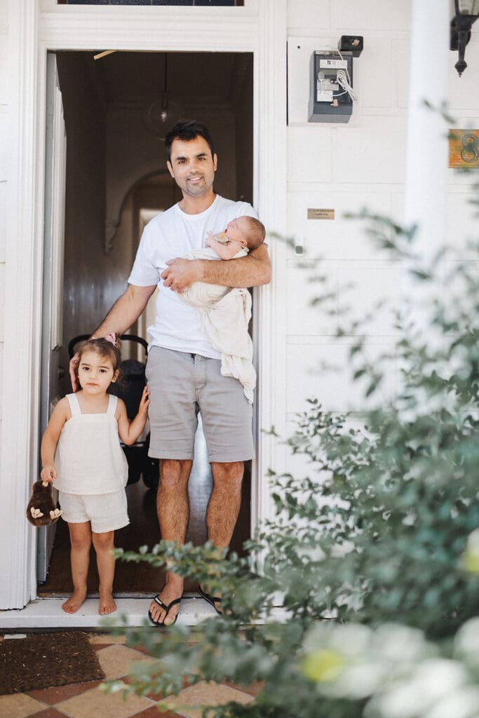 portait photo of dad newborn and daughter